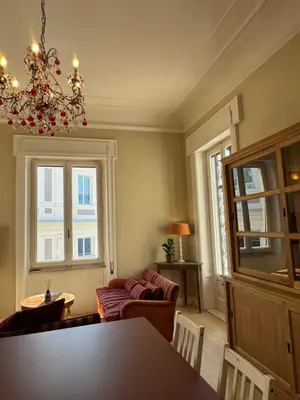 a living room with a couch and a chandelier at Elegante appartamento con terrazzo in Rome