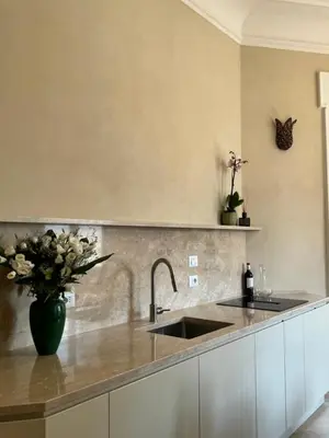 a kitchen with a sink and a vase of flowers at Elegante appartamento con terrazzo in Rome