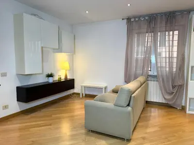 a living room with a couch and a table at 10 Min to Metro Cozy Apartment Near City Center in Rome