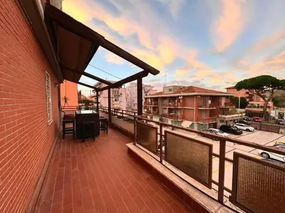 a balcony with a table and chairs on a building at 10 Min to Metro Cozy Apartment Near City Center in Rome