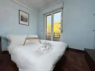 a bedroom with a white bed with towels on it at 10 Min to Metro Cozy Apartment Near City Center in Rome