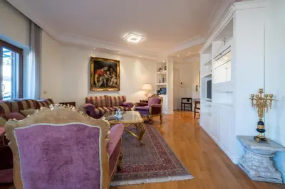 a living room with chairs and a table at Trevi Terrace Penthouse in Rome
