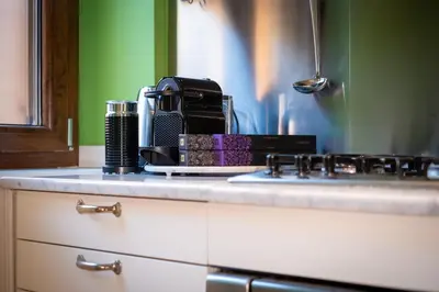 a kitchen counter top with a coffee maker on it at Trevi Terrace Penthouse in Rome