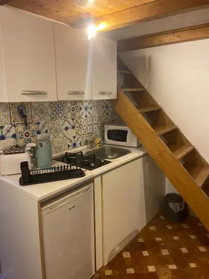 a small kitchen with a sink and a stove at little house in trastevere in Rome