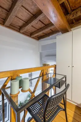 a dining room with a glass table and a chair at little house in trastevere in Rome