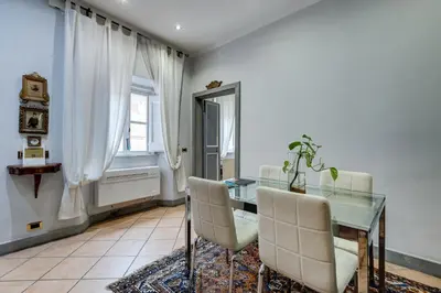 a dining room with a glass table and chairs at Casa Coronari in Rome