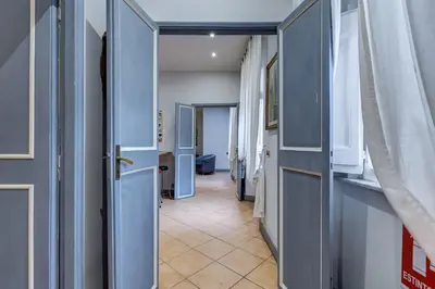 a hallway with blue doors and a tile floor at Casa Coronari in Rome
