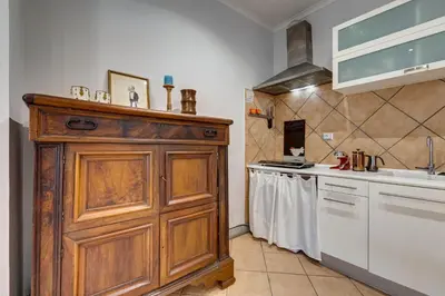 a kitchen with a wooden cabinet and a sink at Casa Coronari in Rome