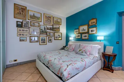 a bedroom with a bed and a wall of pictures at Casa Coronari in Rome