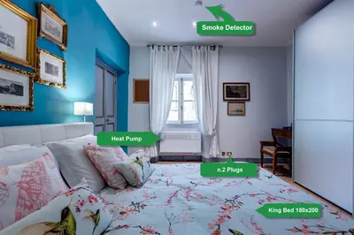 a bedroom with a bed with blue walls and a window at Casa Coronari in Rome