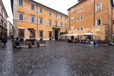a cobblestone street with tents in front of a building at Casa Coronari in Rome