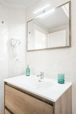 a bathroom with a sink and a mirror at Lilli's Home Garbatella in Rome