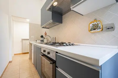 a kitchen with a sink and a stove at Lilli's Home Garbatella in Rome