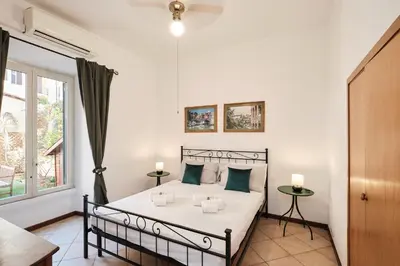a bedroom with a bed and a window at Colosseum 3 rooms & 4 bathrooms with garden in Rome