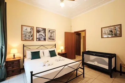 a bedroom with a bed with two towels on it at Colosseum 3 rooms & 4 bathrooms with garden in Rome