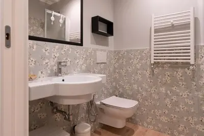 a bathroom with a sink and a toilet at Residenza Lucrezio in Rome