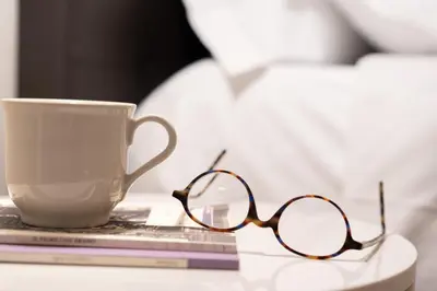 a pair of glasses and a cup on a table at Residenza Lucrezio in Rome