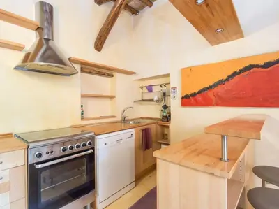a kitchen with a stove and a sink at Charming Luxury Trastevere Apartment in Rome