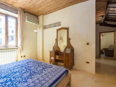 a bedroom with a bed and a dresser and a mirror at Charming Luxury Trastevere Apartment in Rome