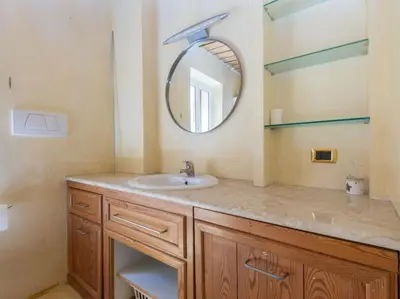 a bathroom with a sink and a mirror at Charming Luxury Trastevere Apartment in Rome
