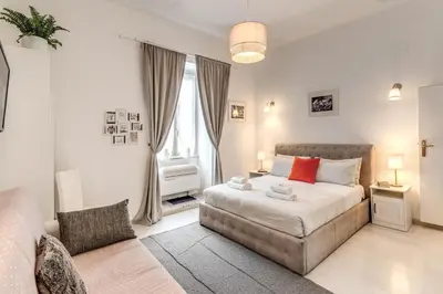 a bedroom with a large bed and a couch at Loft in the Ghetto in Rome