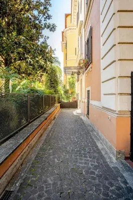an empty alley way between buildings in a city at Loft Torlonia in Rome center town in Rome