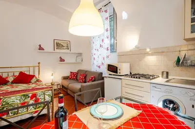 a kitchen and living room with a couch and a table at Loft Torlonia in Rome center town in Rome