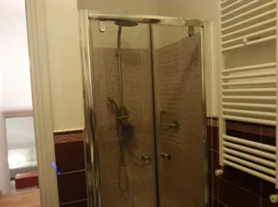 a shower with a glass door in a bathroom at Little Villa Well connected in Rome