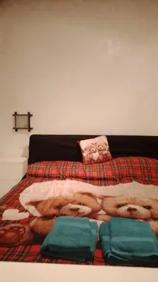 a bedroom with a bed with a blanket with a movie on it at Little Villa Well connected in Rome