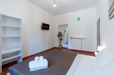 a room with a bed and a clock on the wall at Typical & Cozy Apartment - Testaccio - Trastevere in Rome
