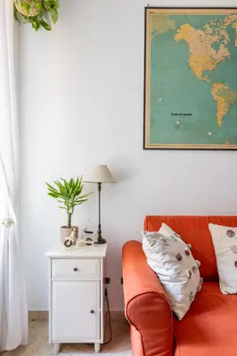 a living room with a couch and a map on the wall at Maurice's Apt, hidden gem in Rome for food lovers in Rome