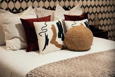 a white bed with red and white pillows at Celeste Suite Reginella in Rome