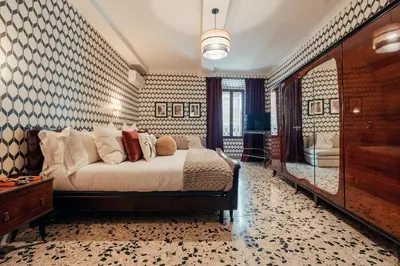 a bedroom with a large bed in a room at Celeste Suite Reginella in Rome