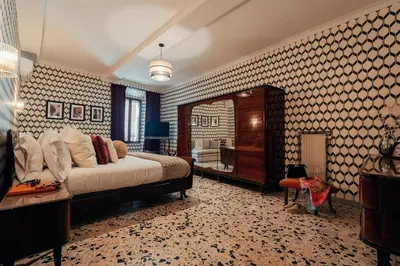 a bedroom with a large bed and a mirror at Celeste Suite Reginella in Rome