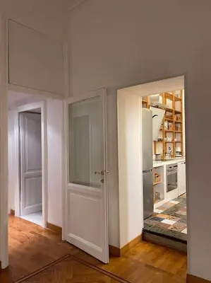 a kitchen with two open doors and a refrigerator at Rome Vatican Home in Rome