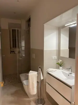 a bathroom with a toilet and a sink and a shower at Rome Vatican Home in Rome