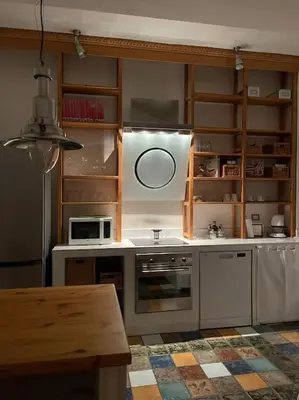 a kitchen with white appliances and a table in it at Rome Vatican Home in Rome