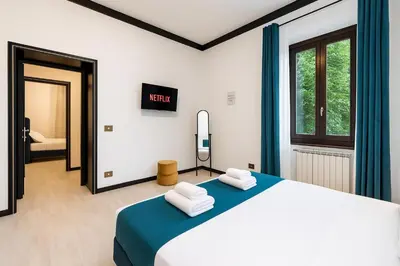 a bedroom with a large bed with towels on it at Trastevere suites Luxury Garden Retreat in Rome