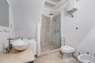 a bathroom with a shower and a toilet and a sink at Suite Experience Spanish Steps Apartment in Rome