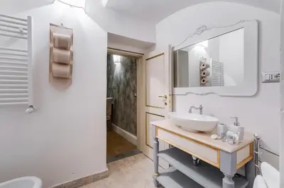 a bathroom with a sink and a mirror at Suite Experience Spanish Steps Apartment in Rome