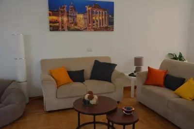 a living room with two couches and a table at VMV Holiday houses in Rome