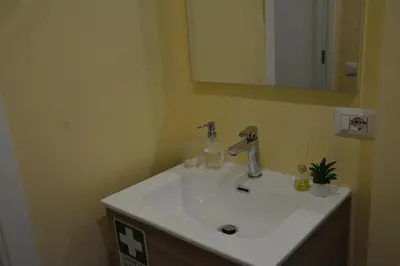 a bathroom with a white sink and a mirror at VMV Holiday houses in Rome