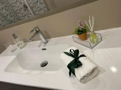 a white bathroom sink with a towel on it at VMV Holiday houses in Rome