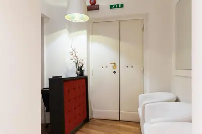 a living room with a closet and a red cabinet at History Suite Essence in Rome