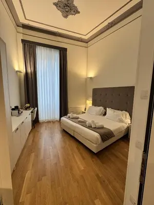 a bedroom with a large bed in a room at History Suite Essence in Rome