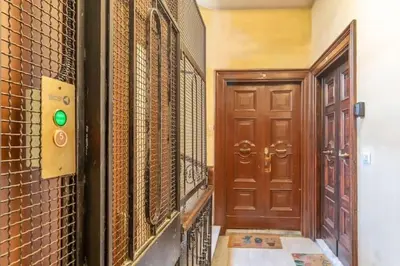 a hallway with a door and a brick wall at Residenza Cocchina Apt in Rome
