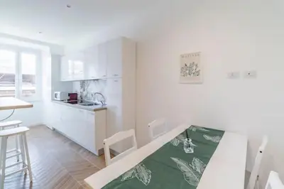 a white kitchen with a bed in a room at Residenza Cocchina Apt in Rome