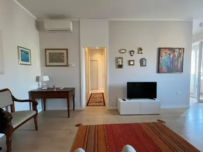 a living room with a television and a table at Anna Lucia's Flat vicino a Trastevere e al San Camillo in Rome