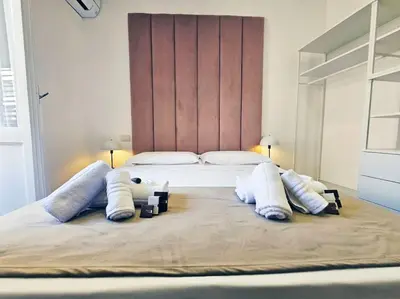 a bedroom with a large bed with white pillows at Via Aubry 1- Vatican Museum in Rome