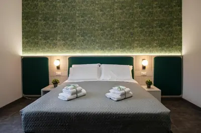 a bedroom with a bed with two towels on it at DoppioSei in Rome
